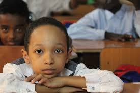 A pupil at his desk in class