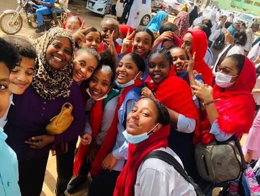 Pupils and a teacher outside school